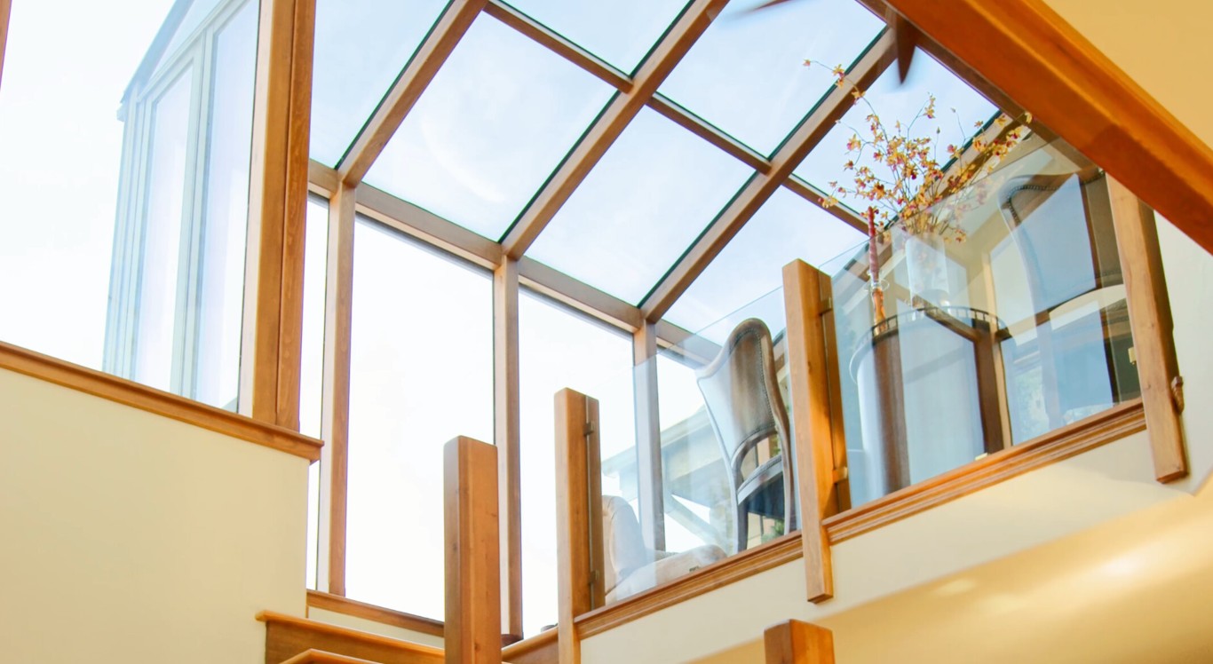 Three-season sunroom with glass roof panels